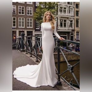 This long sleeve wedding dress made by high quality satin .